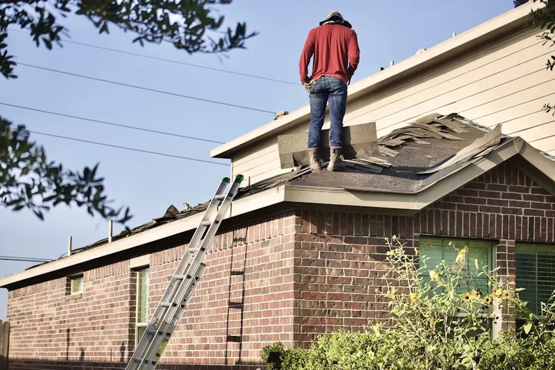 Professional roofer working on a residential roof in Wortendyke